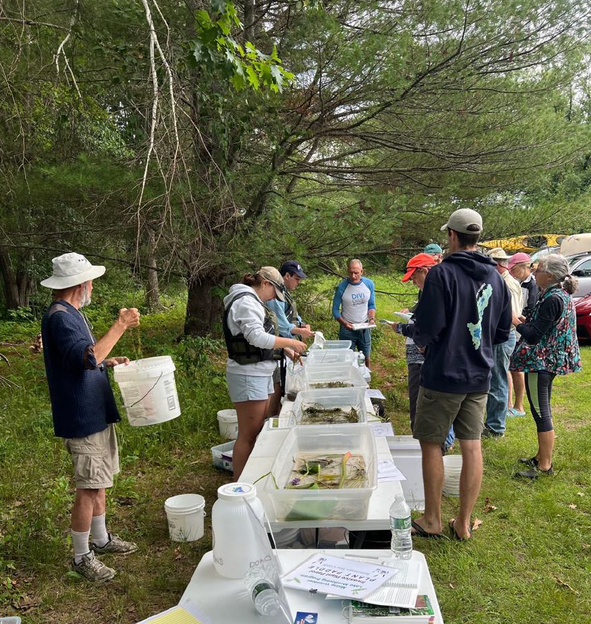 People gather as Abby and the LSM team showcase information pertaining to lake safety and conservation. 