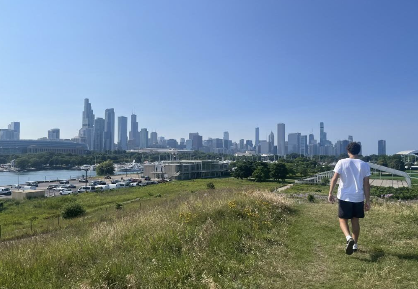 Andrew's silhouette is backdropped by the city skyline.