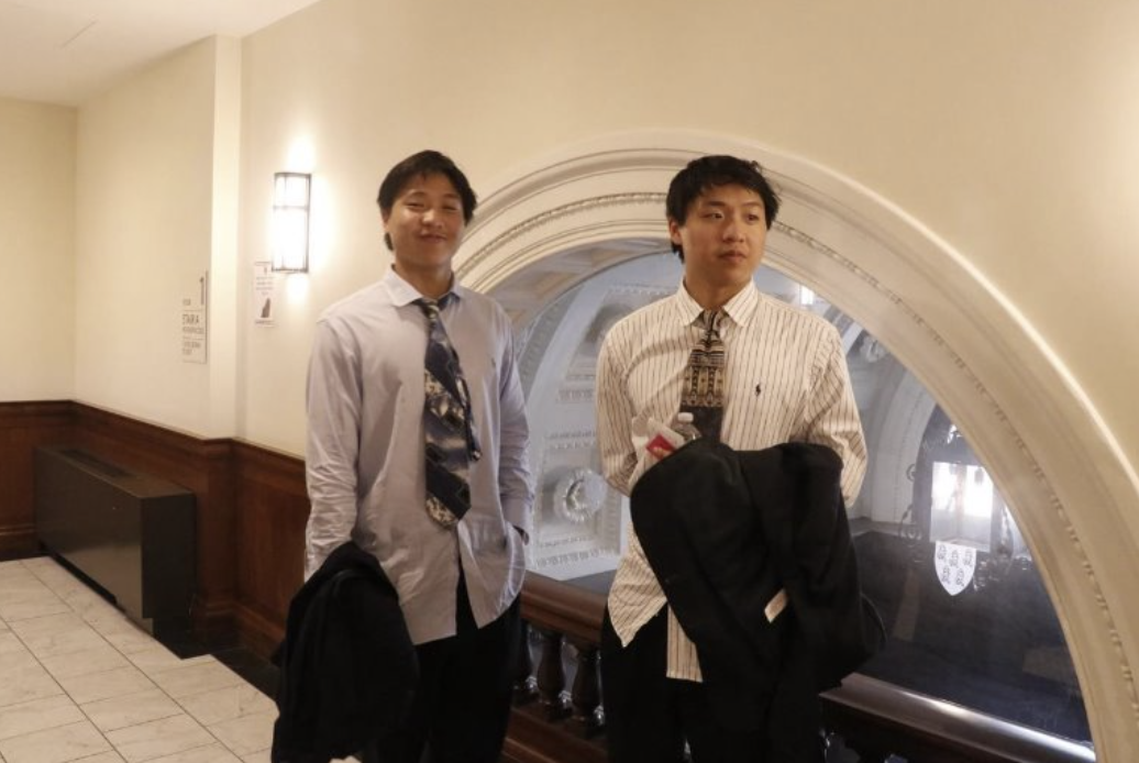 Dylan poses with their brother after their first day of work.