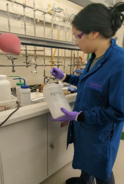 Ella conducts research at lab station.