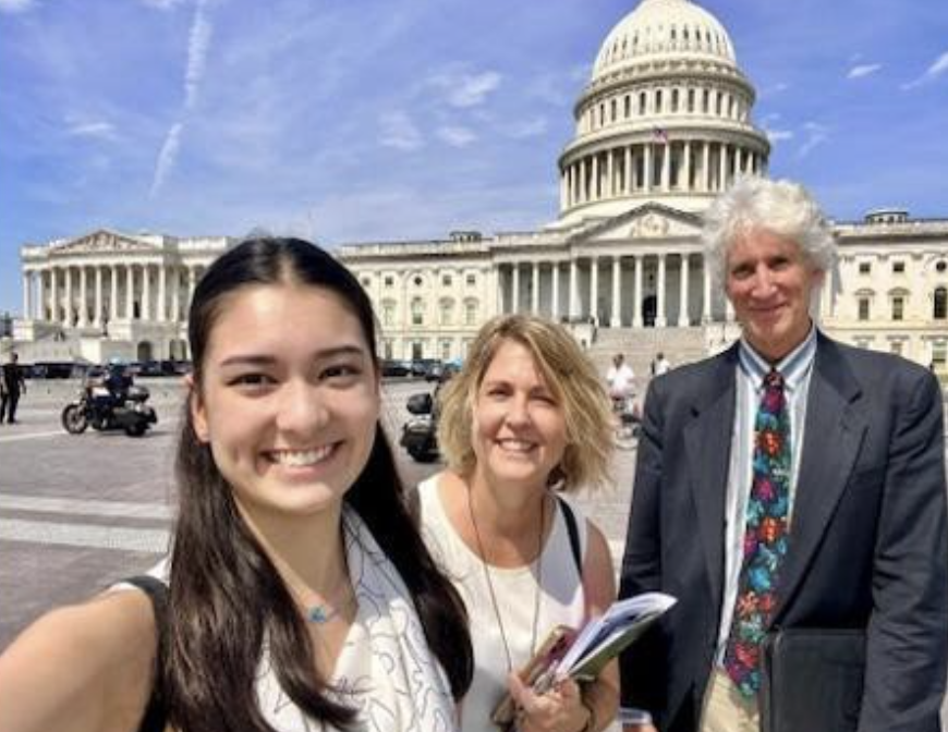 Ellie poses in front of the White House with members of their team.