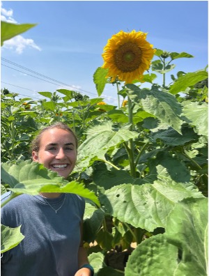 Fiona Jenkins standing next to a sunflower