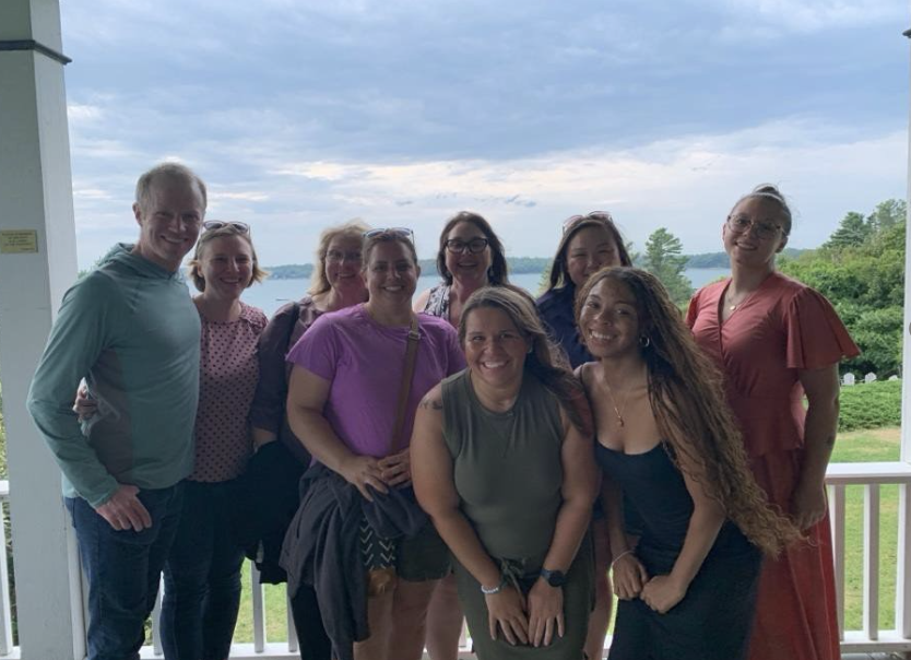 Imani poses alongside the entirety of the Casco Bay Dental team. 