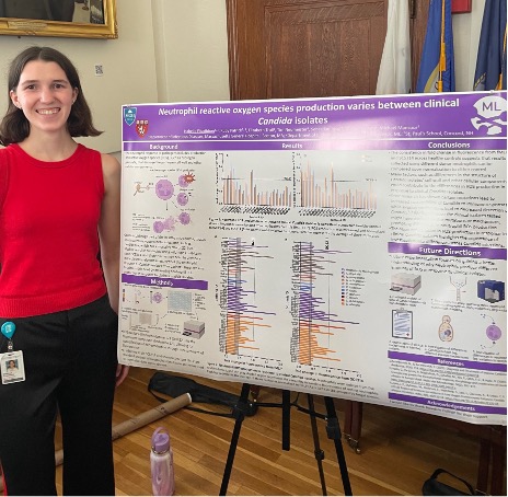 Isabelle Fitzgibbon standing in front of her research poster