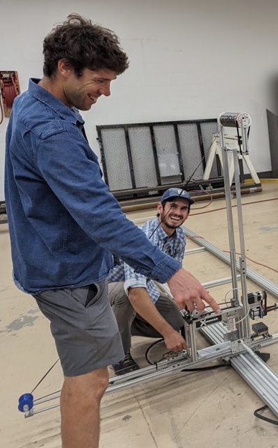 James and their coworker work on a structural segment of the rocket.