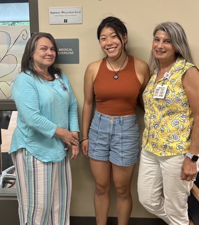 Jasmine poses with supervisors in front of their MidCoast office.
