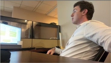 Joe Gaetano seated and looking on at a computer screen