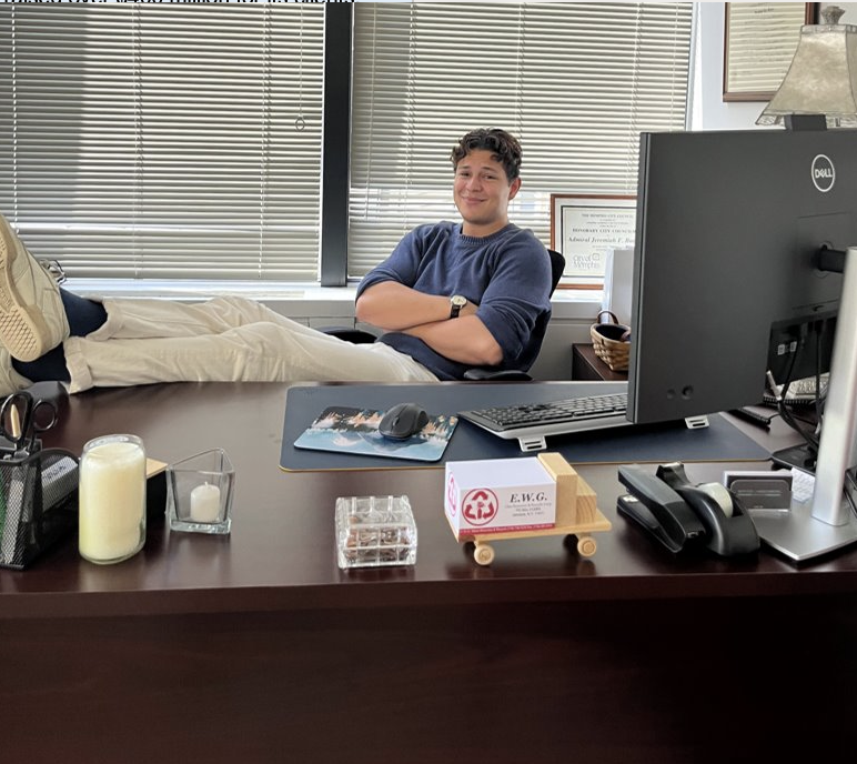 Jonas poses for a picture at their office desk.