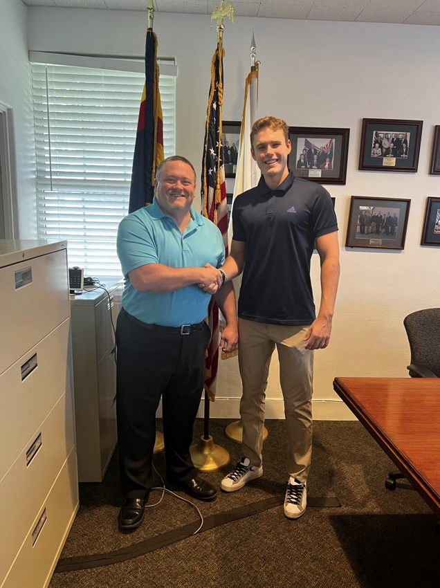 Image of Jonathan shaking hands with a man in an office.