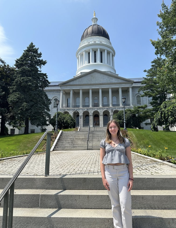 Kaitlyn poses in front of the State House.