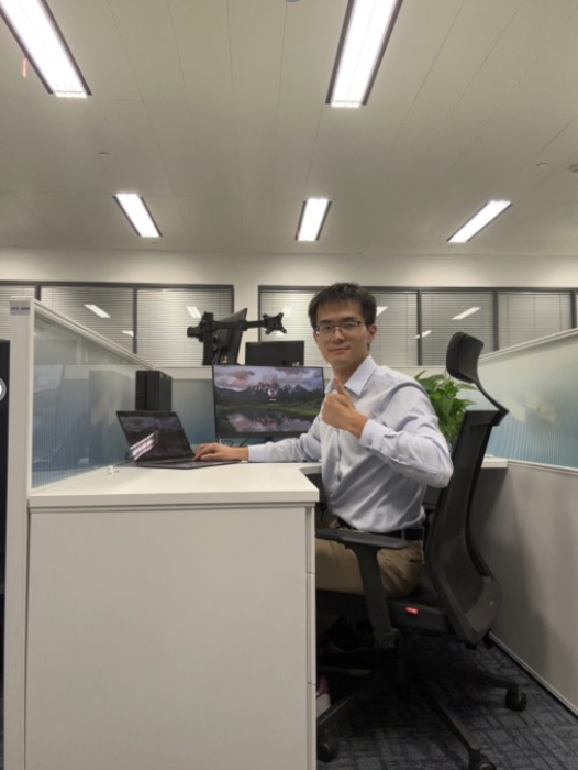 Linguo poses for the picture at their office desk.