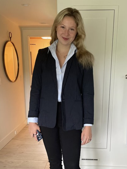 Mary poses in their work uniform. 