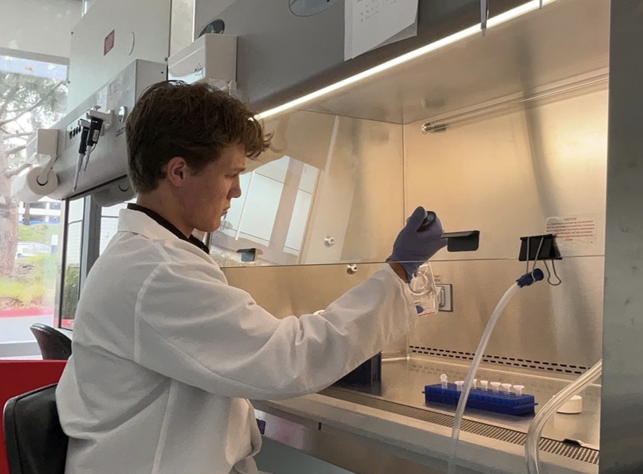 Mateo handles laboratory equipment at their station.