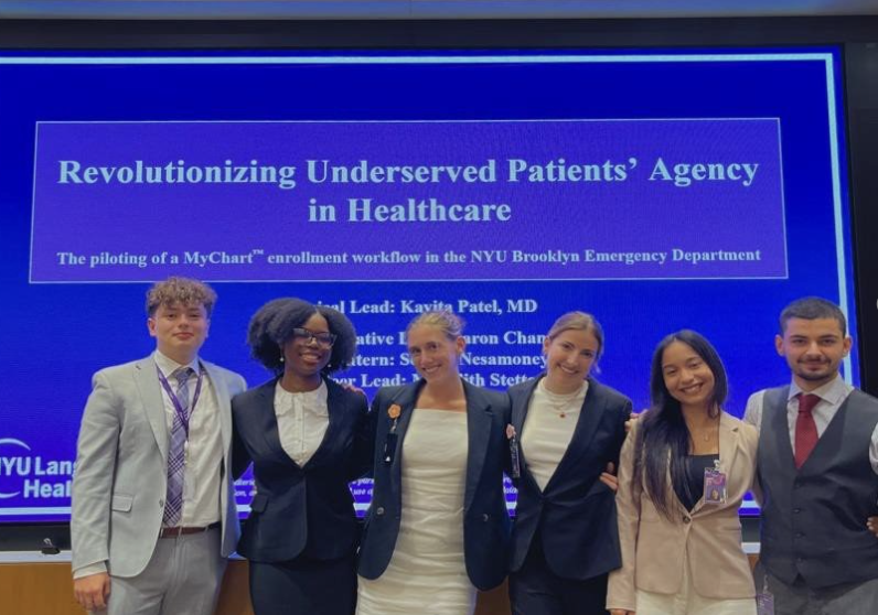 Meredith poses with their healthcare team in front of their presentation slide.