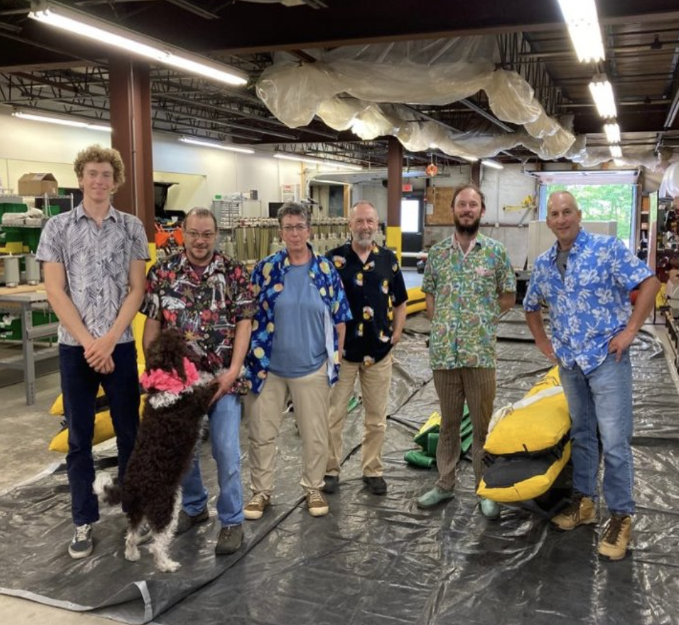 Miles poses with the Maritime Applied Physics Corporation team.