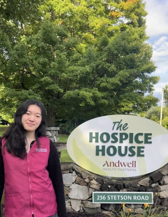 Miranda poses in front of the Andwell Hospice House sign. 