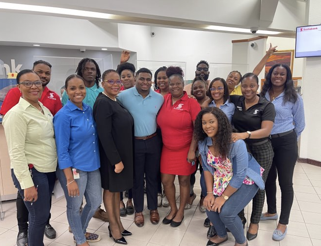 Mitri poses for the picture with many of their coworkers.