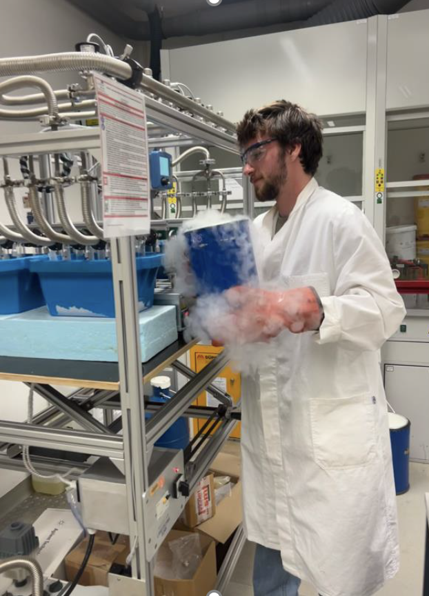 Sasha handles a vaporous substance in the lab.