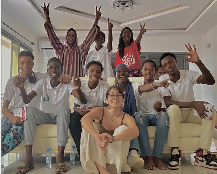 Selima posing with their students.
