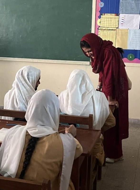 Shumaim pictured in a classroom with students.
