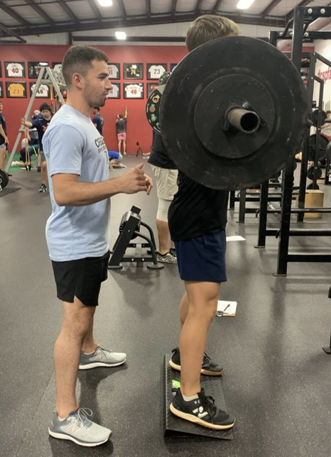 Stephen assisting a client with weights.