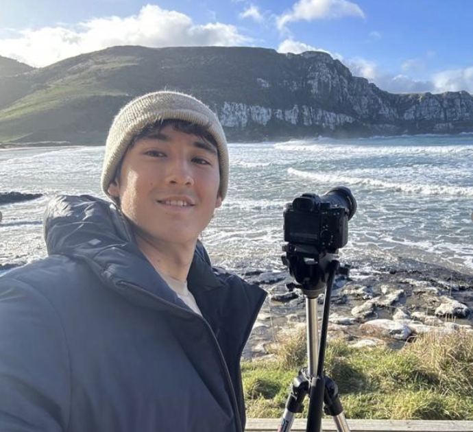 Taira photographs a New Zealand cliff.
