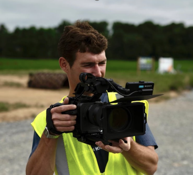 Thomas operates a camera on set.