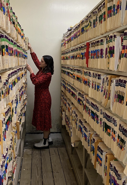 Student examines shelf of case files.