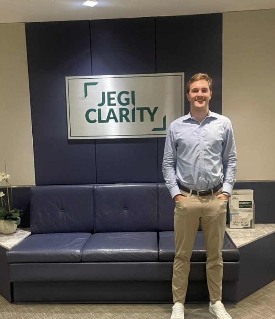 Will poses in front of the JEGI CLARITY sign.