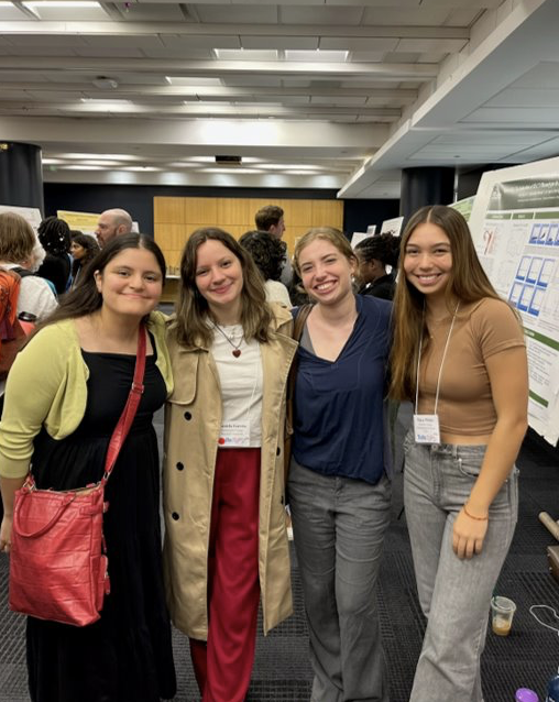 Yanevith with three coworkers posing at the Biomedical Summer Research Poster Presentation at Tufts.