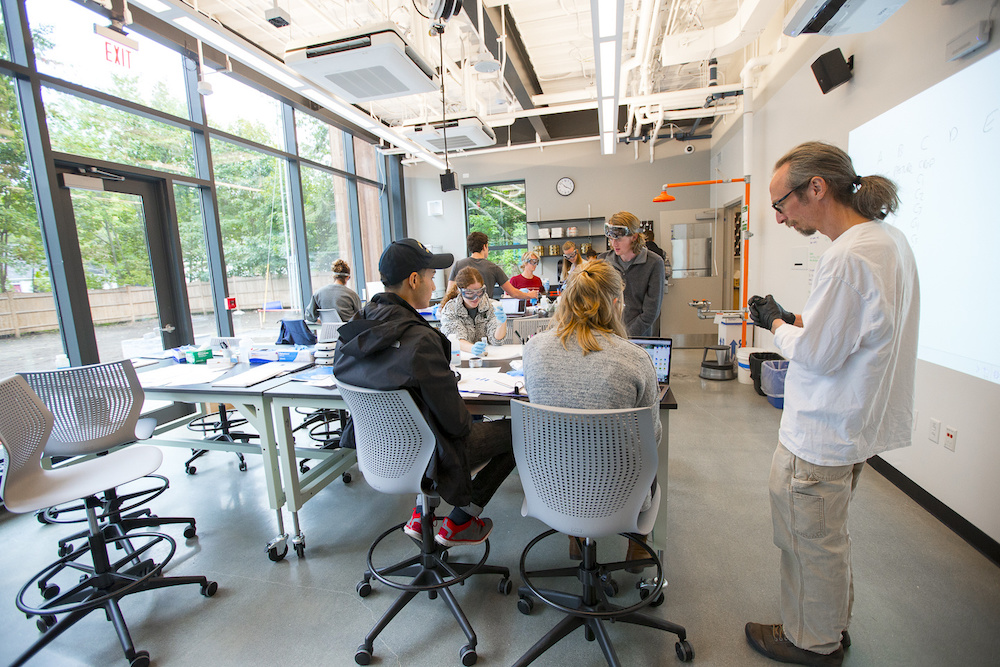 Phil Camil with students in  science classroom