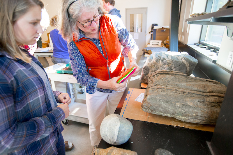 Joanne with a student looking at rocks