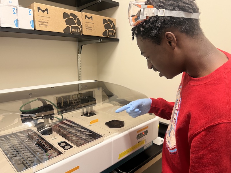 Student pointing at nutrient analyzer