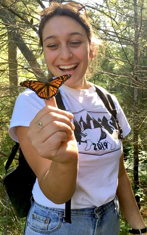 Student with butterfly on her thumb