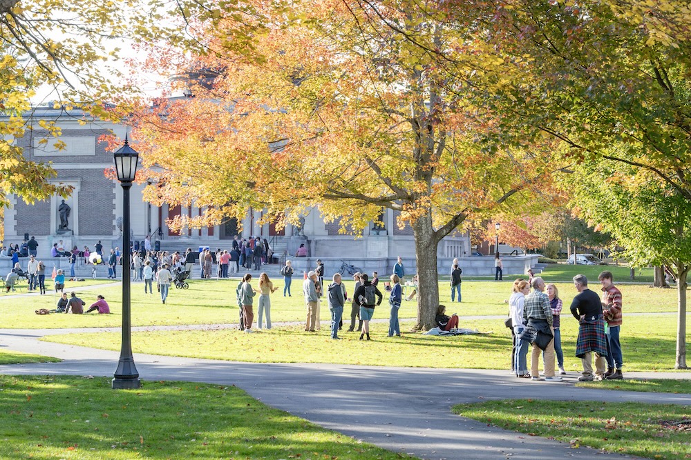 Scenic fall campus with many people in background