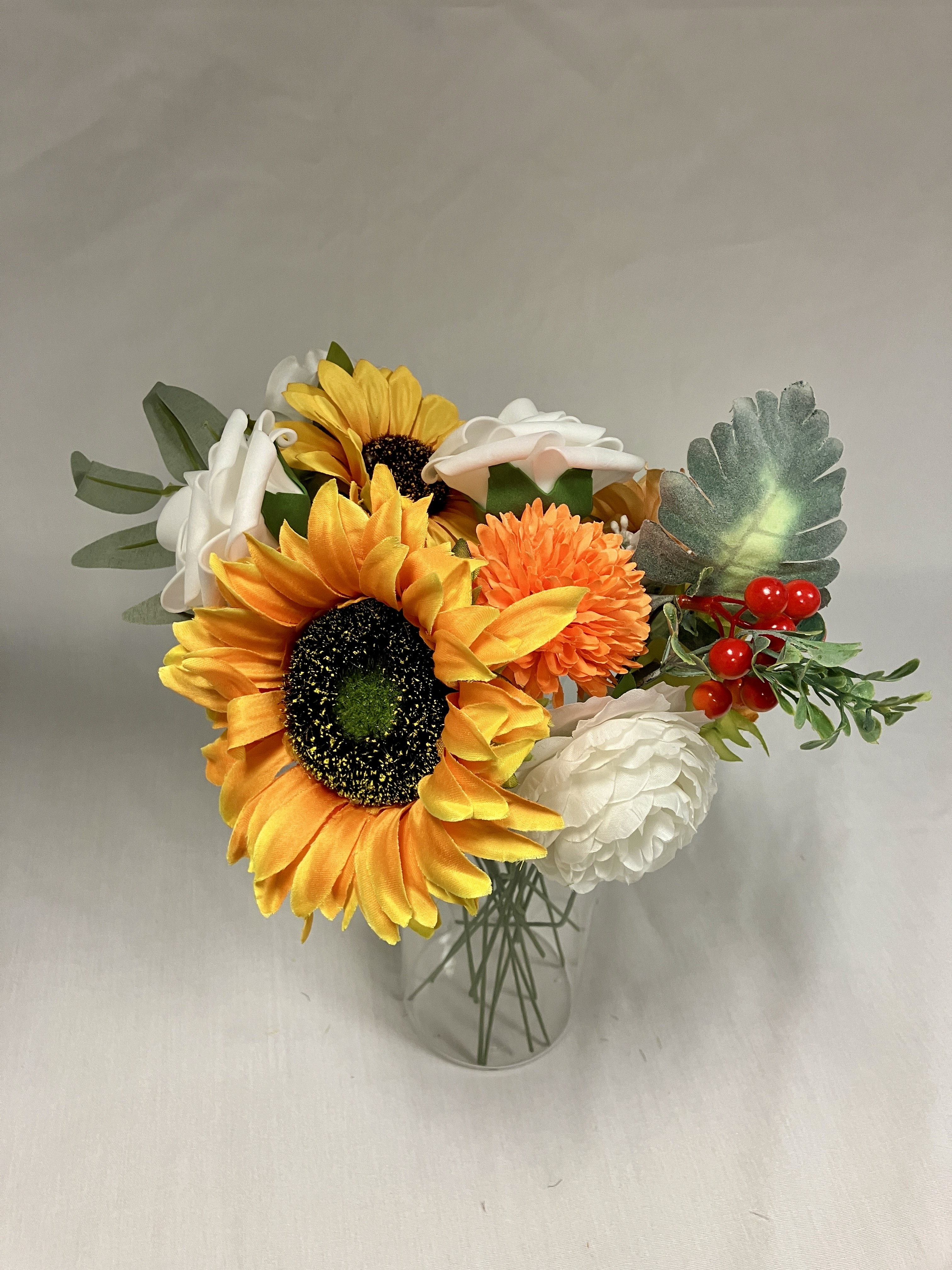 Vase filled with variety of silk flowers