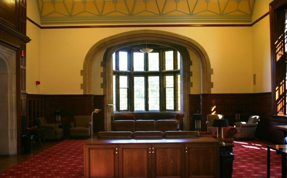 Large room with leather chairs, wooden tables