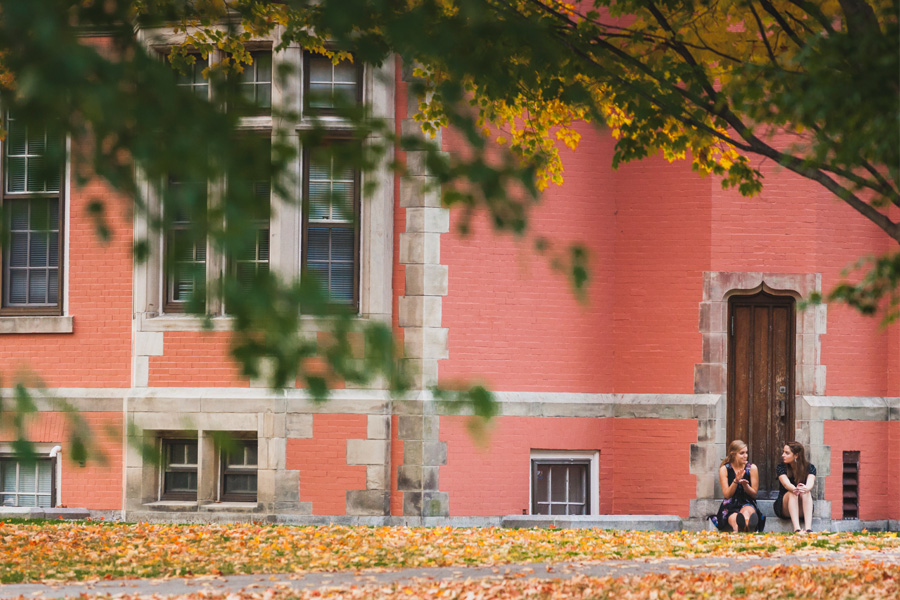 Two people talking in front of Searles Science Building.
