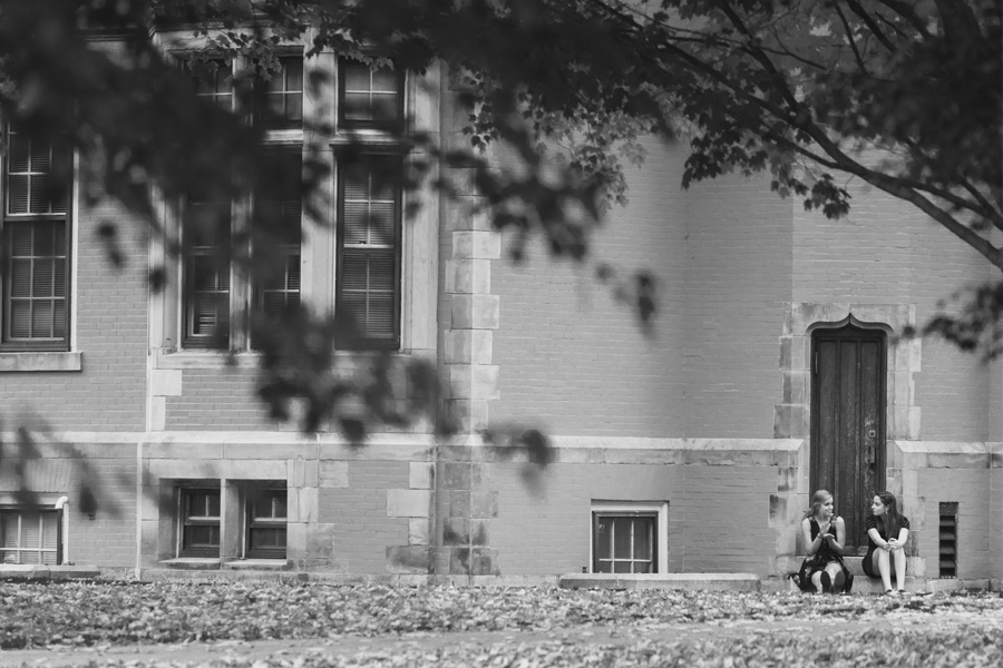 Two people talking in front of Searles Science Building.