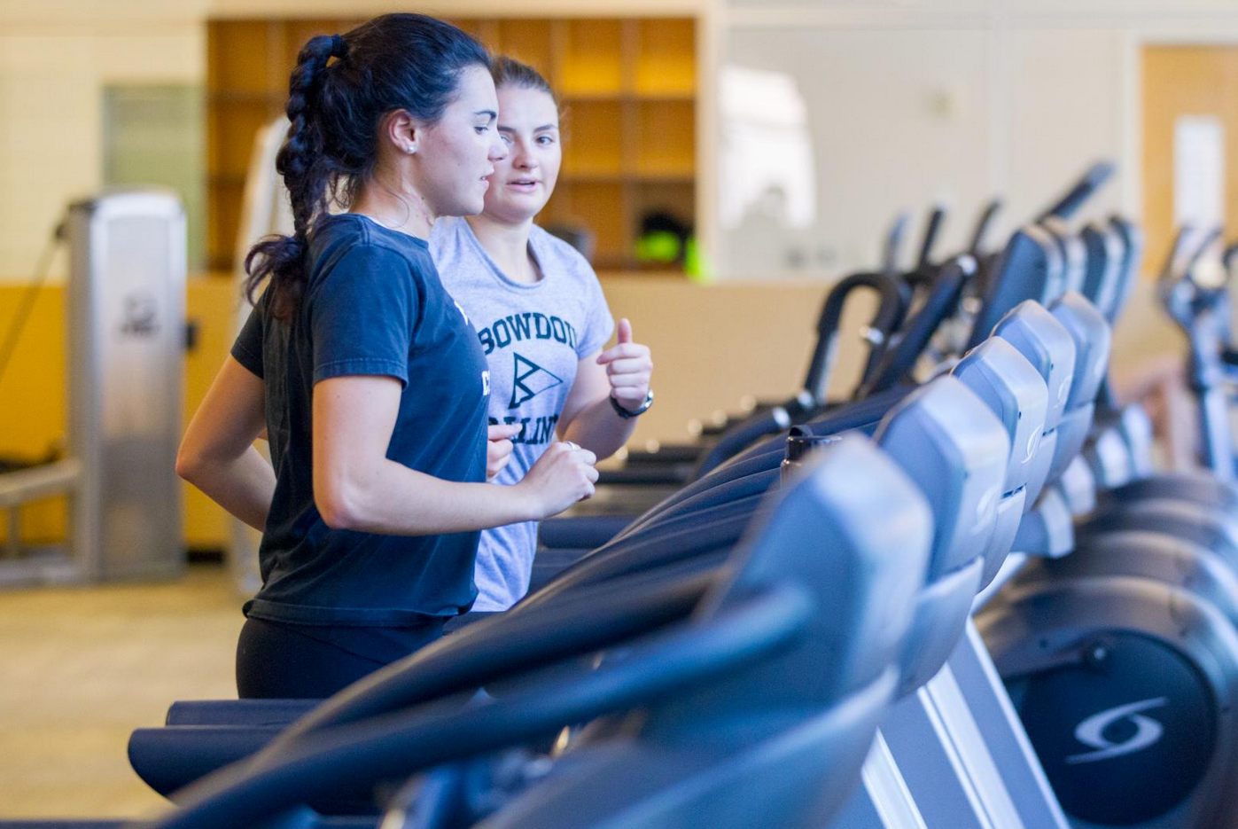 Student running in the elliptical. 