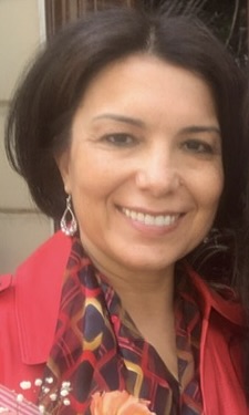 women with dark brown hair and red shirt with a flower