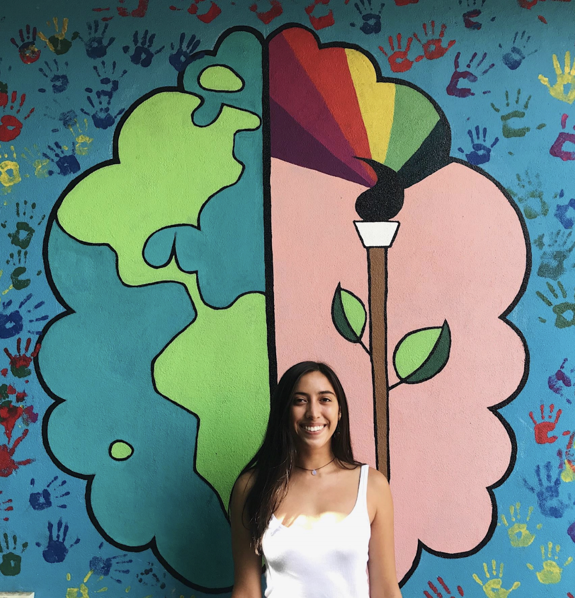Portrait of Liana in front of a mural
