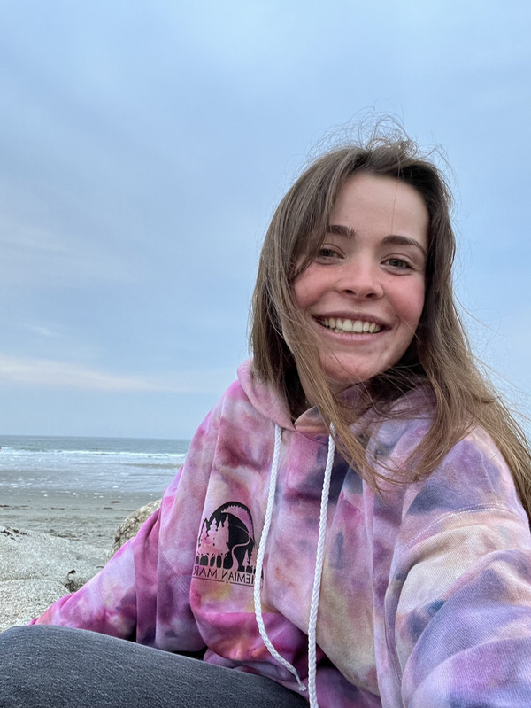 Selfie of Aura smiling on a beach.