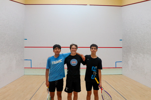 Henry stands next to two others on a court.