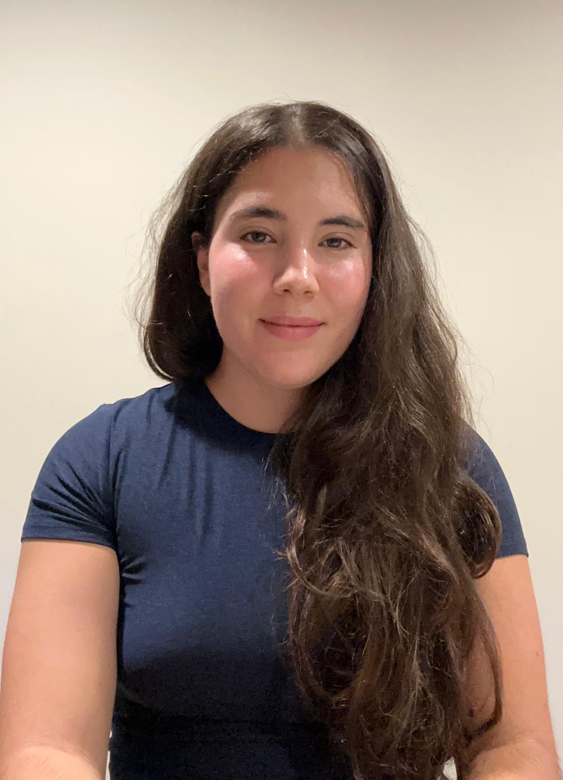 Larah smiles softly at the camera. 