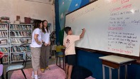 A group of people working at a white board