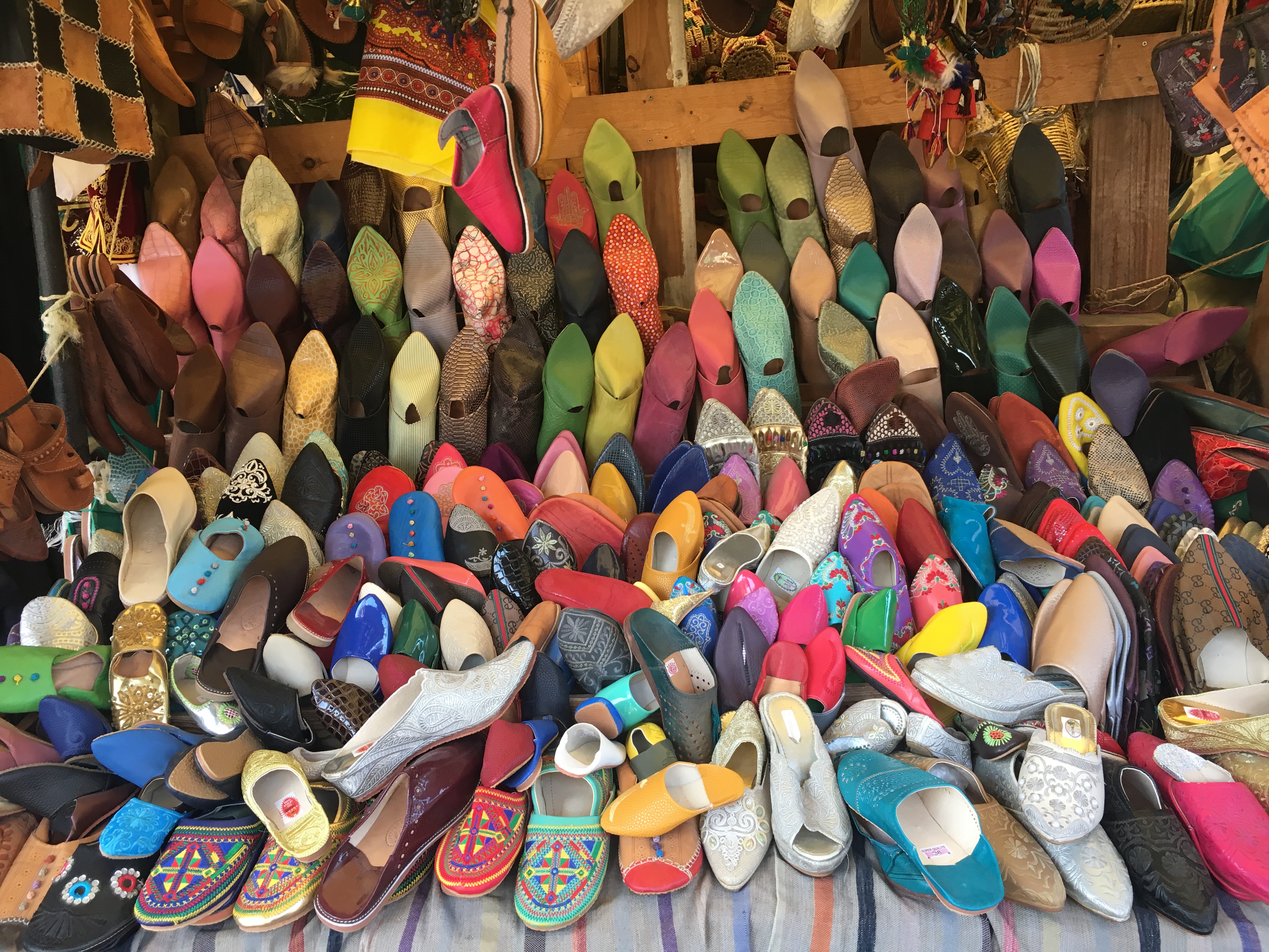 Multicolored leather mules displayed in market