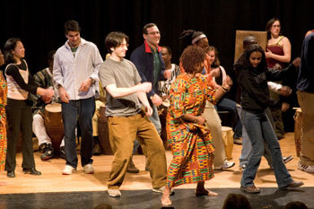 Students dance with a drumming performer