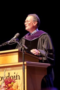 Mills stands at podium during speech