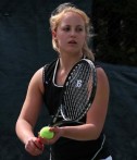 Female student plays tennis
